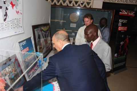 British Council Director Peter Brown shows London 2012 Gold Medallist Stephen Kiprotich items of the London 2012 exhibit donated by the British High Commission and British Council