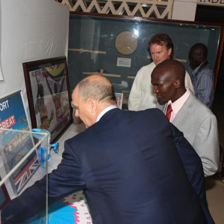 British Council Director Peter Brown shows London 2012 Gold Medallist Stephen Kiprotich items of the London 2012 exhibit donated by the British High Commission and British Council